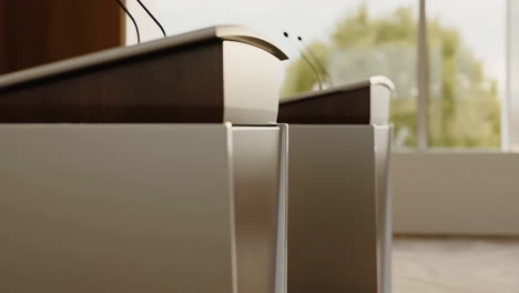empty modern podiums with microphones in a conference room