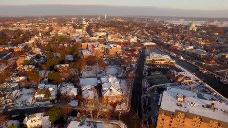 aerial wide shot of historic annapolis during a golden sunrise with the state capital building and us naval academy, and seven river bridge