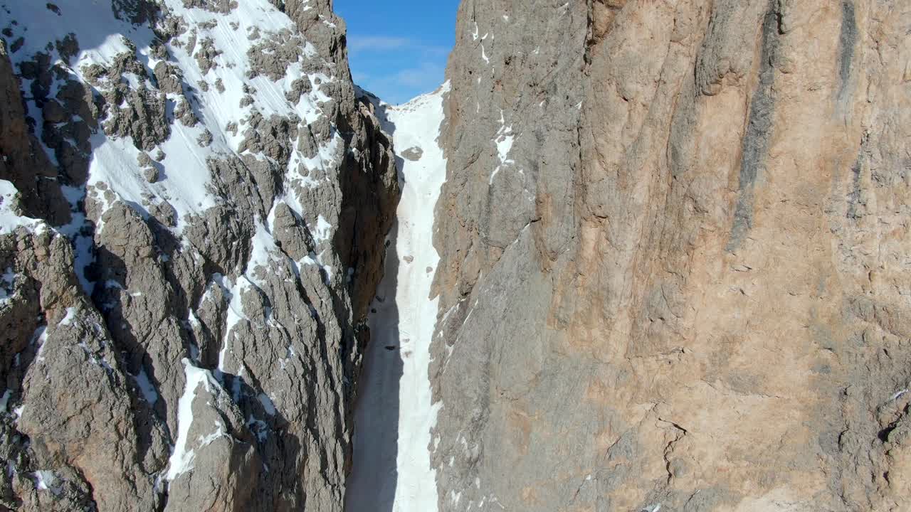 vuelo cinematográfico de drones entre el pico de las montañas nevadas y la impresionante vista de la cordillera en el fondo