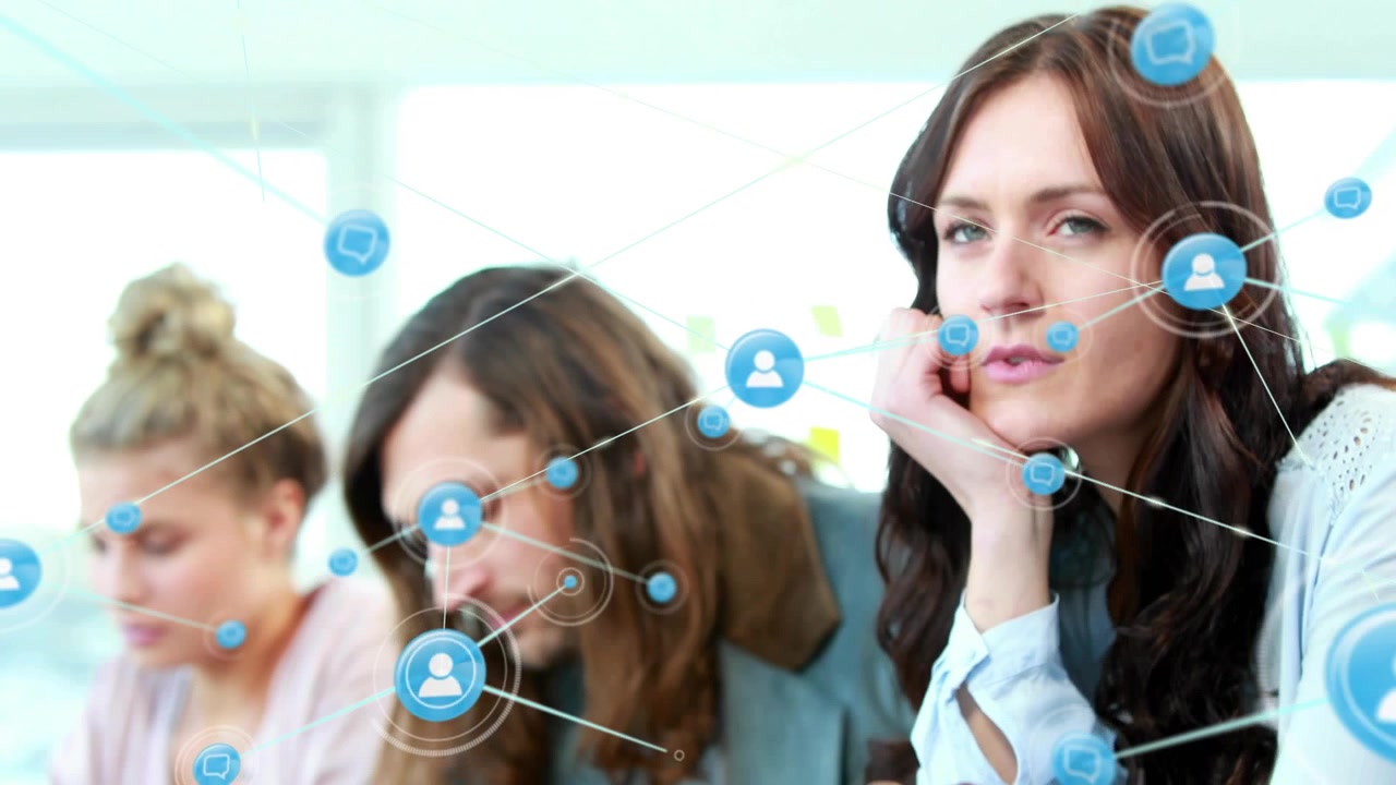 Woman tapping smartphone and watching blue network nodes linking laptops and coworkers in business
