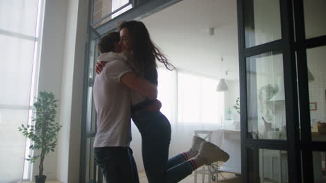 happy couple spinning around in new house. young couple celebrating relocation.