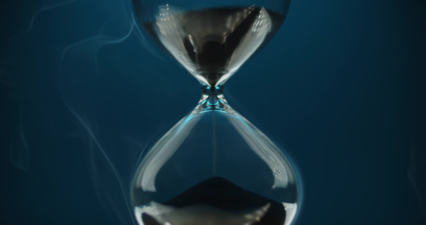 Hourglass on green to blue background