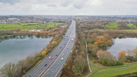 Aerial-drone-cinematic-video-footage-of-the-M1-Motorway-near-the-city-of-Wakefield,-West-Yorkshire,-UK