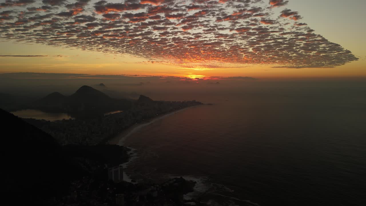 Aerial view of sunrise casting golden light over the city of Rio de Janeiro