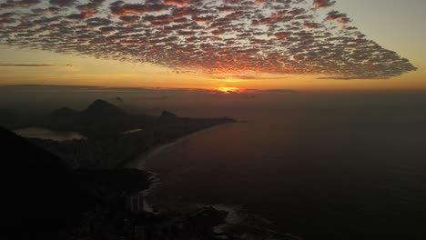 aerial view of sunrise casting golden light over the city of rio de janeiro