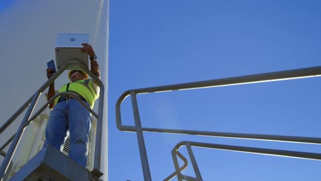 Male-engineer-using-mobile-phone-while-working-on-laptop-4k