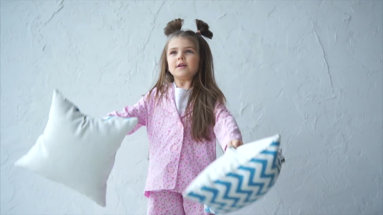 Adorable Girl Having a Pillow Fight