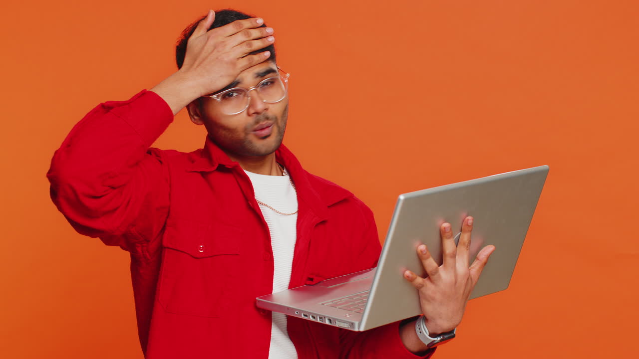 Displeased indian man use laptop surprised by bad news fortune loss game fail lottery results