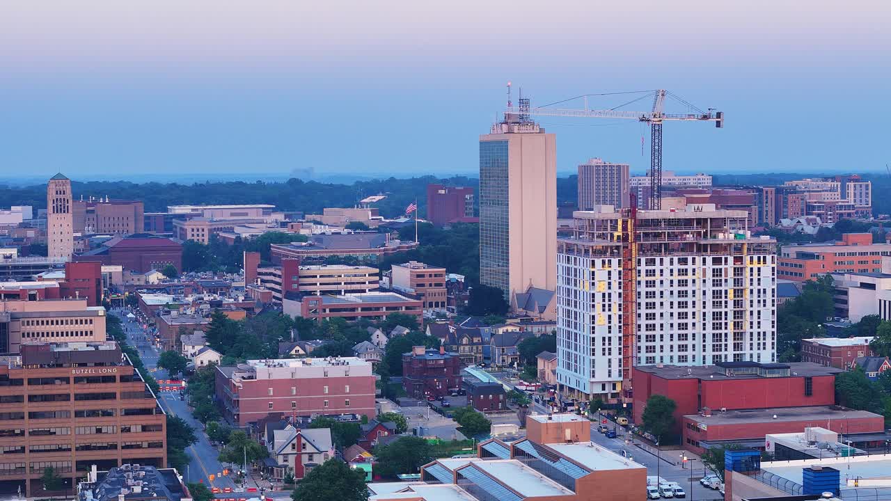 Aerial view of downtown Ann Arbor with construction crane and city buildings at dusk, Michigan, USA
