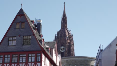gothic cathedral spire and half-timbered houses in germany