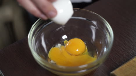 baking ingredient. fresh egg falling into bowl. cooking food. food ingredient