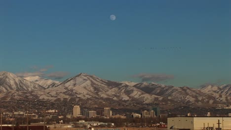 long shot of salt lake city utah with the moon rising behind