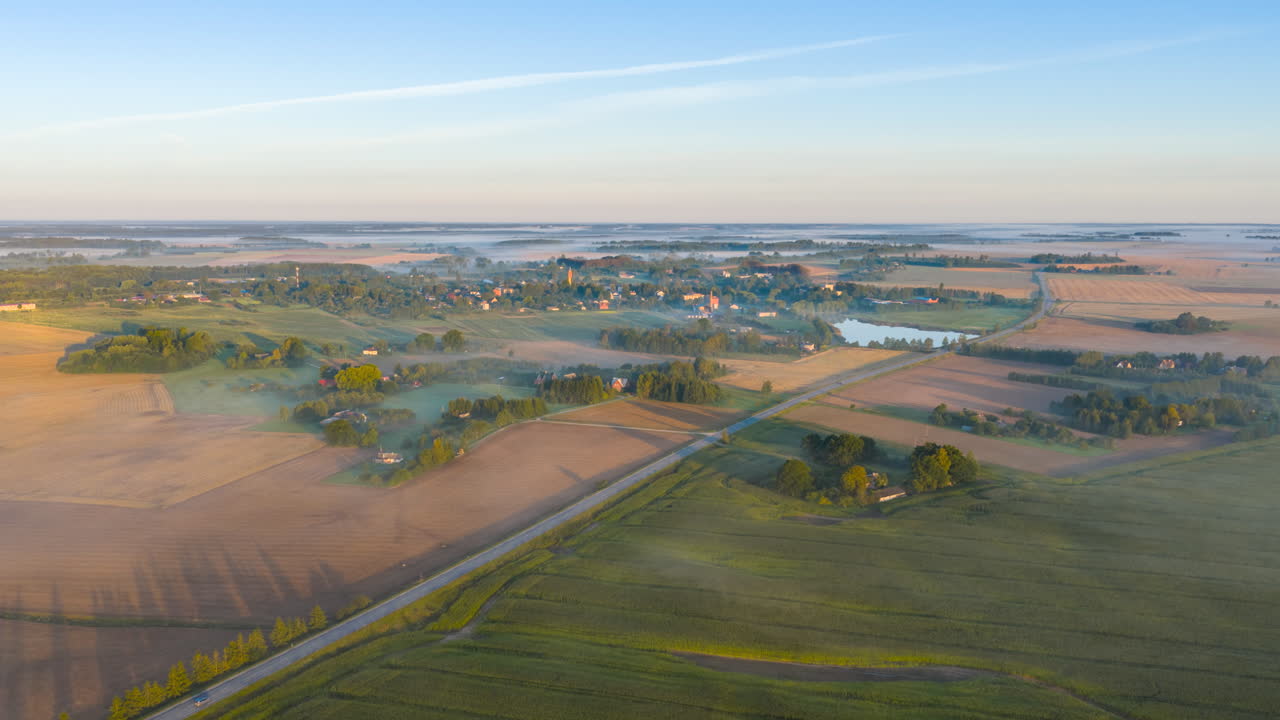 Road Through Fields Near Remote Village On A Misty Morning. Timelapse
