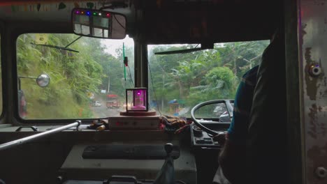 windscreen wipers going on sri lankan bus on a rainy day driving fast down rural roads