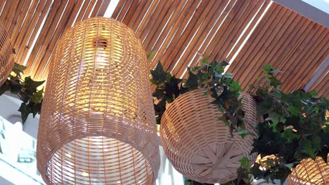 wicker lanterns and hanging planters with ivy