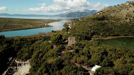 drone view of butrint archeological site, albania, europe pull back from castle to reveal amphitheater