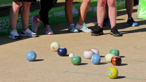 players engage in a lawn bowls game on a sunny day, showcasing skill and precision on the grass lawn