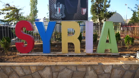 dolly in to colorful syria sign marking the route into damascus