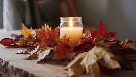 autumn candle decoration with fall leaves