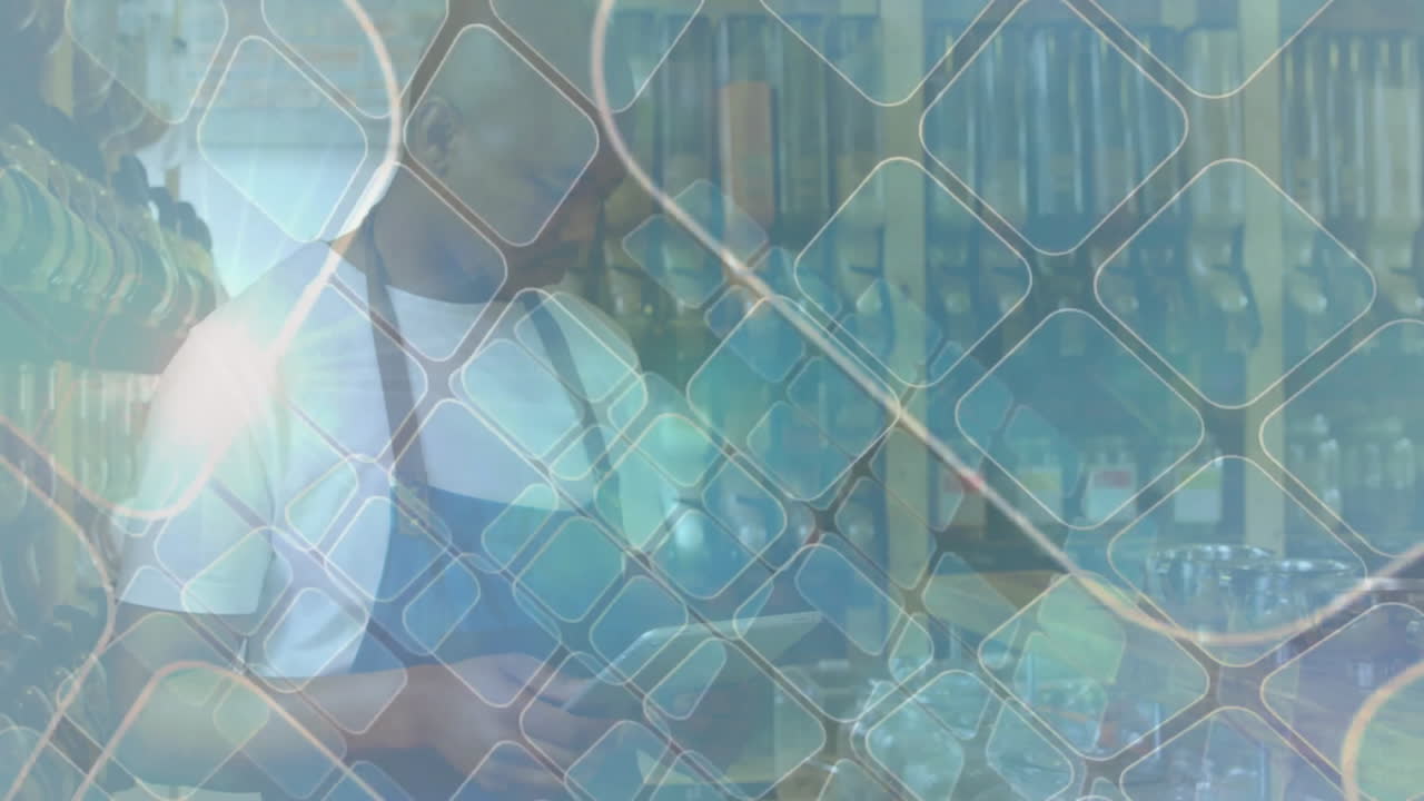 Worker in apron handling glassware in laboratory with geometric overlay animation