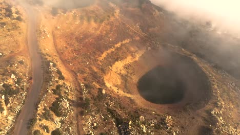 aerial drone footage capturing misty lakes and cloud formations at sunset, revealing nature's tranquil beauty from above