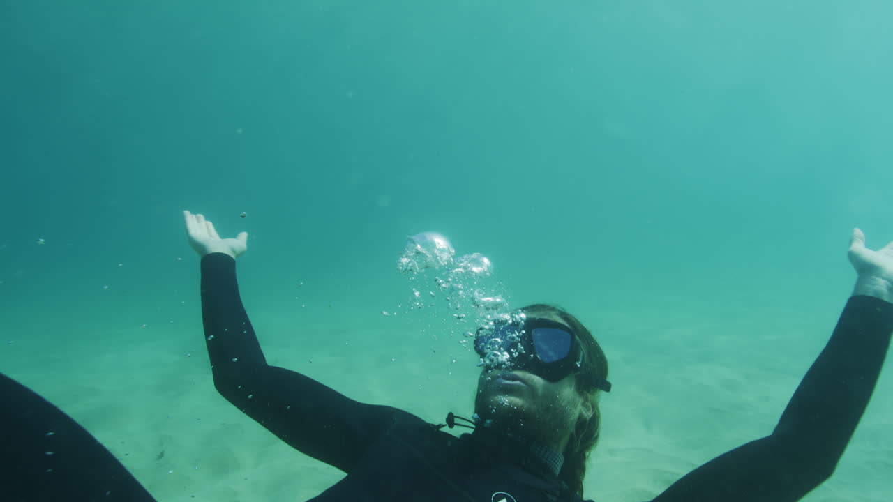 Underwater capture of bubble rings created by a photographer, swimming in the clear waters of the Pacific Ocean