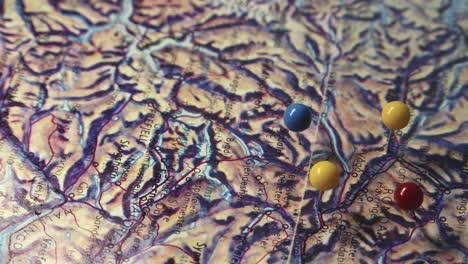 coloured pins mark points on topographic map of norwegian mountains