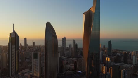4k aerial shot of kuwait city’s skyline at sunset with iconic skyscrapers and the gulf horizon. ideal for tourism, real estate, and middle east cityscape features. category: travel – urban landscape.