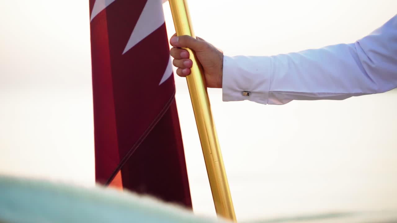 A knight holding Qatar flag near the sea