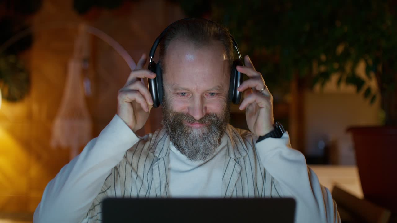 Man Working on Laptop at Night