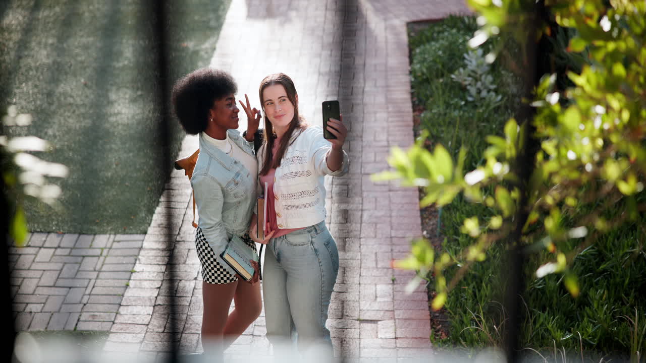 Two women taking a selfie on a college campus