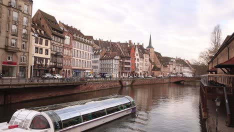 boat cruise with windows floating down river along strasbourg france in alsace region of europe