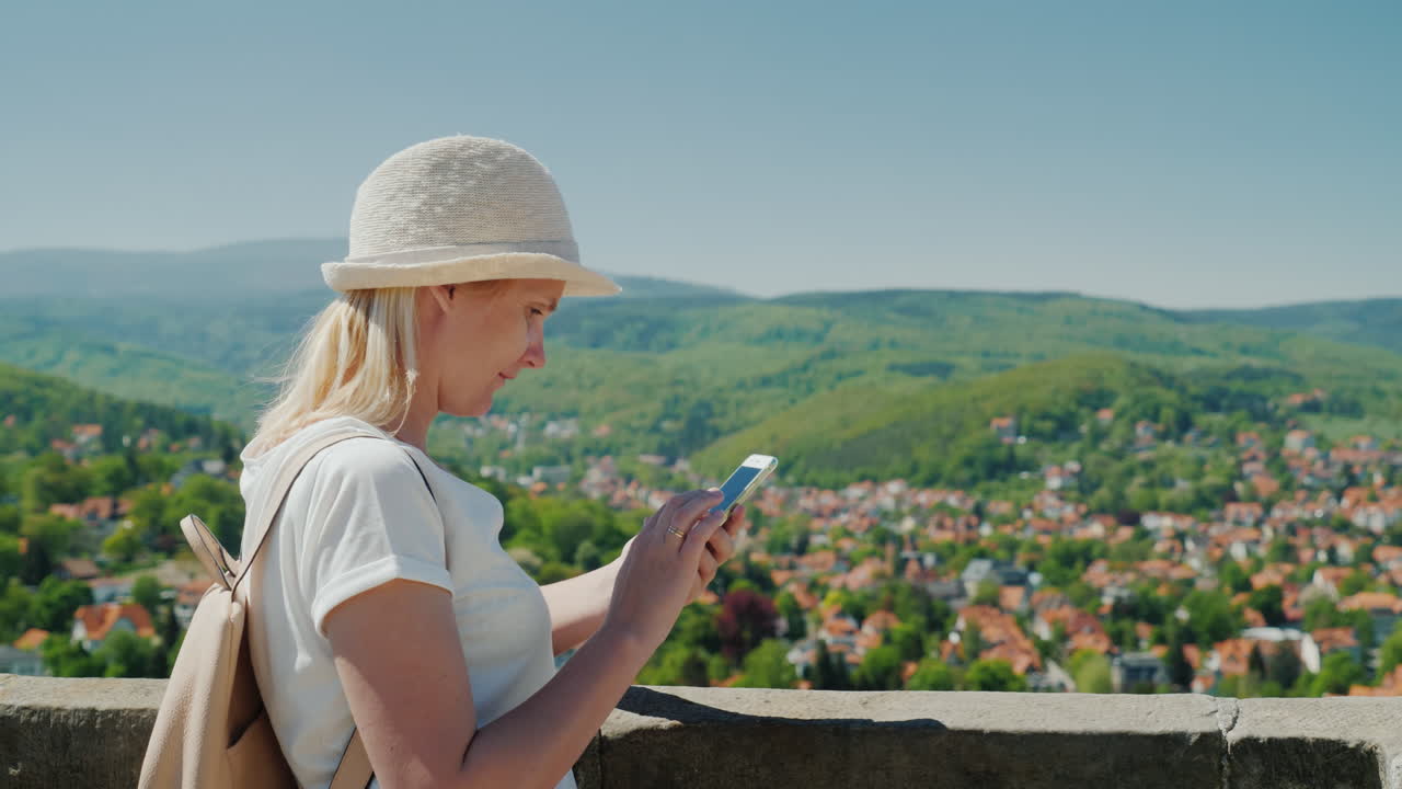 turista con un teléfono inteligente en el campo alemán