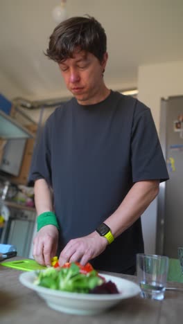 man preparing a salad in the kitchen