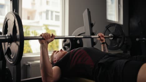 man lifting weights in gym