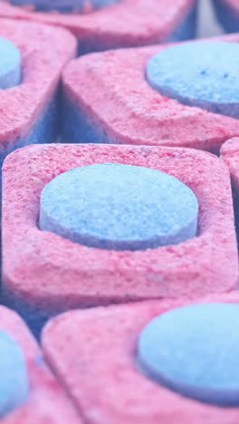 capsules of bluered color for washing dishes in an automatic machine vertical video