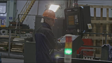 factory worker operating cnc machine