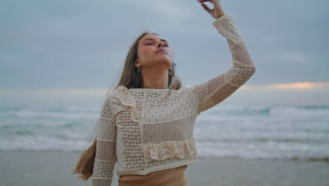 Lady-legs-going-ocean-waves-closeup.-Romantic-woman-touching-long-hair-at-sea