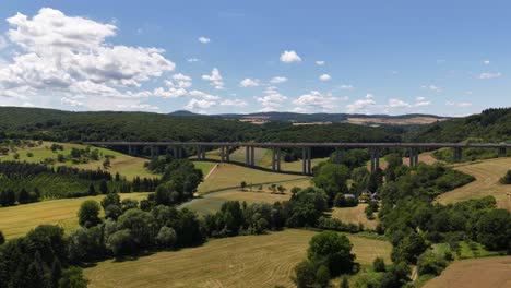 tall bridge, tall brucke over a valley, highway infrastructure in germany. aerial video