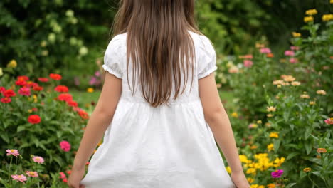 girl in a white dress in a flower garden