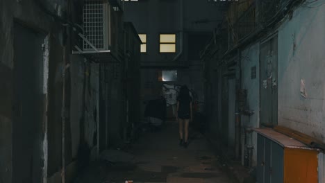 shot of a girl walking confidently in a small dark eerie and dirty street with rats running on the ground during the night in a city