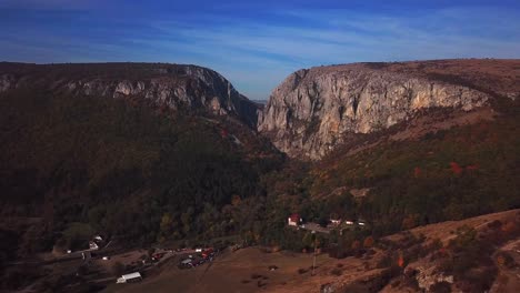 drone shot towards cheile turzii canyon, on an autumn evening