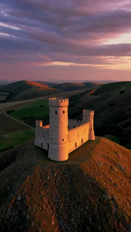 ancient castle on hilltop at sunset
