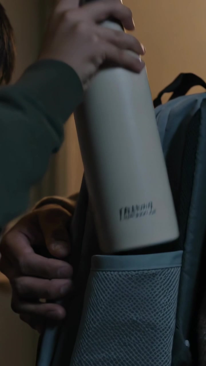 Vertical video: Handing dad giving bottle at hall, son placing into blue backpack pocket leaving