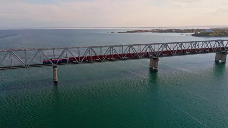 aerial of a train crossing on a rail bridge spanning the kapchagay or qapshaghay bogeni reservoir in almaty region, kazakhstan