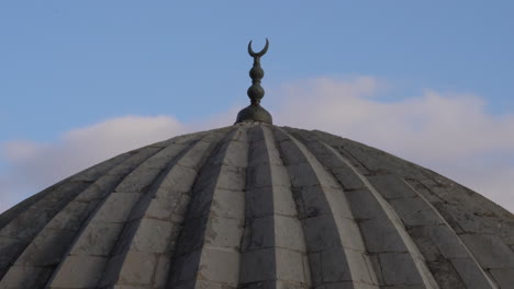 the camera zooms in on the metal pillar on one of the domes of the zinciriye madrasa and sees it closely