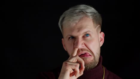 funny stupid stylish man picking nose, removing boogers, uncultured habit, bad manners