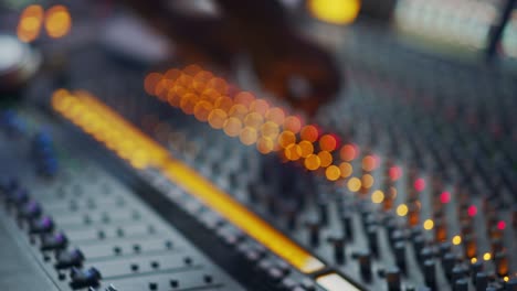 audio engineer, music creator, musician, artist works in the music record studio, uses surface control desk eq mixer. buttons, faders, sliders to broadcast, record, play hit song. close-up focus