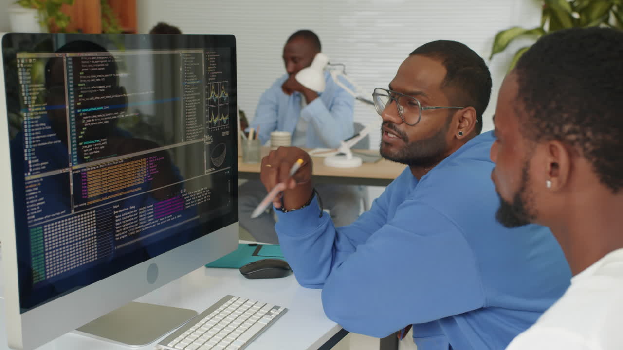 Two Programmers Fixing Bags in Script while Coding at Office
