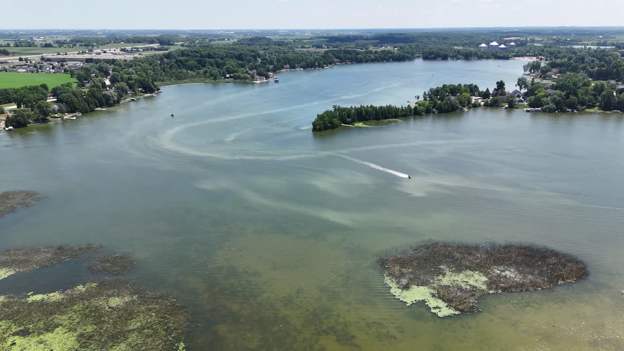 Aerial overhead view of a jet ski on a small inland lake. Taken in Random Lake Wisconsin on a summer day